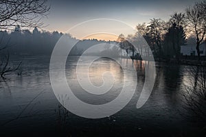 Beautiful view on a frozen lake in winter season in beautiful sunset and mountains