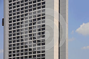 Beautiful view of geometric urban landscape of hotel building block with elevator lift outside and blue sky in central business di