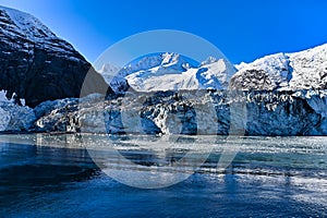 Beautiful view of the glaciated mountains and icefall with blue sky