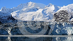 Beautiful view of the glaciated mountains and icefall with blue sky photo