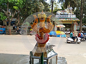 Beautiful view of Goddess Face in the Yellow Color Trishula or Trident in front of the Sri Gangamma Devi Temple Near Kadu