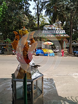 Beautiful view of Goddess Face in the Yellow Color Trishula or Trident in front of the Sri Gangamma Devi Temple Near Kadu