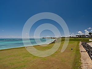 Beautiful view of the golf field near the blue ocean in the Dominican Republic on a sunny day