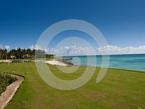 Beautiful view of the golf field near the blue ocean in the Dominican Republic on a sunny day