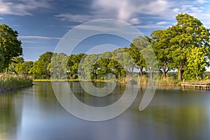 Riverbank of Gota canal in golden evening sunlight photo