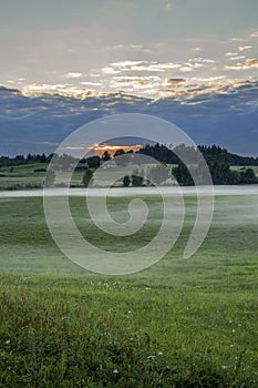 Beautiful view of green fields and meadows at sunset