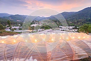 Beautiful view of greenhouse in tropical forest at twilight. Flower plants growing inside greenhouse. Organic greenhouse. Chiang