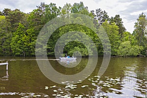 Beautiful view of group of men on motorboat on green trees background.