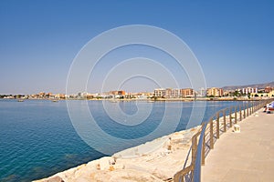 Beautiful view of the harbor in Manfredonia, Foggia, Italy with a calm sea under a bright blue sky