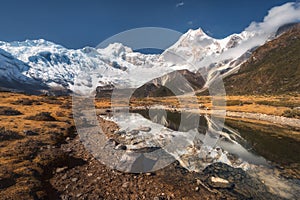 Beautiful view with high rocks with snow covered peaks, stones i