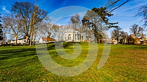 Beautiful view of a hill with green grass and the tea dome or Gloriette in the Proosdij park