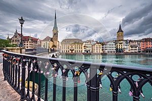 Beautiful view of historic city center of Zurich with famous Fraumunster Church and Munsterbucke crossing river Limmat.