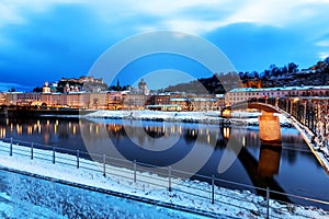 Beautiful view of the historic city of Salzburg with Salzach river in winter during blue hour, Salzburger Land, Austria