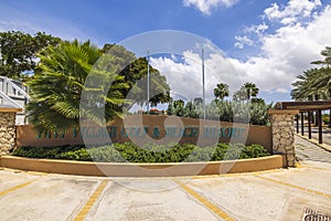 Beautiful view of hotel grounds with logo of Divi Village Golf Hotel - Beach Resort resort in Aruba. Oranjestad.