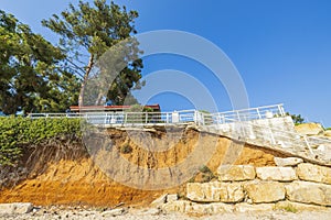 Beautiful view of house with white metal fence on cliff edge.