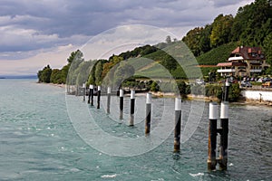 Beautiful view of houses on a green coast by Meersburg Lake Constance, Germany