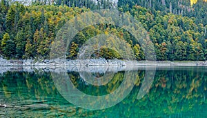 Beautiful view of idyllic colorful autumn scenery with Dachstein mountain summit reflecting in crystal clear Gosausee mountain