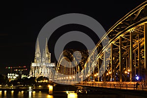 Beautiful view of illuminated Hohenzollern Bridge and Cologne Cathedral at night in Cologne, Germany