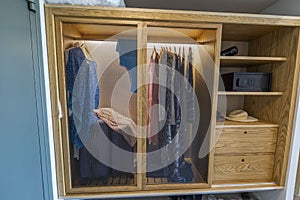 Beautiful view of interior of the clothes in wardrobe and compartment for safe in hotel room.