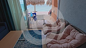 Beautiful view of interior of hotel room overlooking Atlantic ocean through the exit to patio.