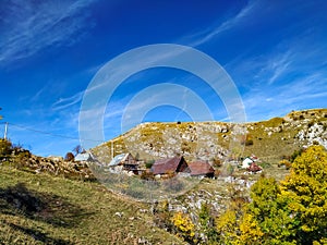 Beautiful view of the isolated mountain village houses with traditional architecture rooftops surrounded by natural environment,