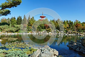 Beautiful view of Kagamiike Mirror Pond against Tahoto Pagoda in Japanese garden. Public landscape park
