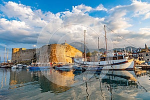 Beautiful view of Kyrenia Harbour Girne Limani, ancient castle and docked boats in a sunny day in Northern Cyprus