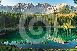 Beautiful view on Lago di Carezza lake or Karersee with mountains reflection in italian dolomites alps, Italy photo
