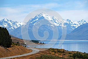 A beautiful view of a lakeside road leading to one of the most famous destination for tourist, Mount Cook National Park, in a