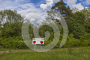 Beautiful view of landscape of nature with signboard for announcement of prices for  sale of strawberries.