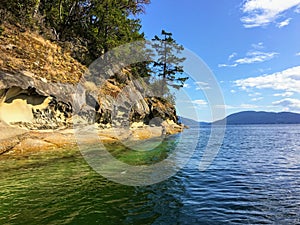 A beautiful view of a long shoreline of sea caves caused by coastal erosion on wallace island, in the gulf islands