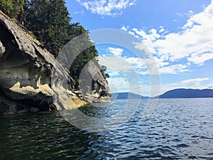 A beautiful view of a long shoreline of sea caves caused by coastal erosion on wallace island, in the gulf islands