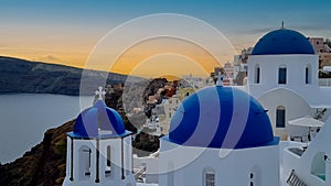 Beautiful view of look out with sunset sky scene background and blue dome church at Oia village, Santorini,Greec