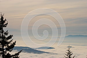 Beautiful view from a lookout over a cloud and fog filled valley in British Columbia