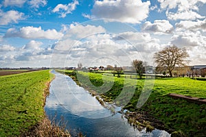 Beautiful view of the low grasslands with water filled ditches in the west of the Netherlands