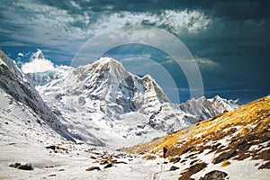 Beautiful view of majestic snow-covered mountains and dramatic cloudy sky. Annapurna, Nepal