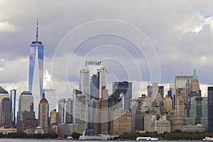 Beautiful view at Manhattan from river side. Skyscrapers on blue sky with white clouds background. New York.