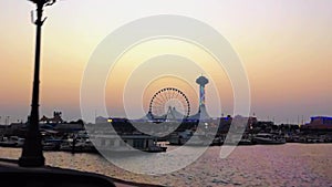 Beautiful view of the Marina Mall and Marina eye wheel at sunset - Abu Dhabi beach and boats