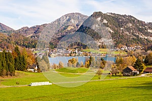 Beautiful view of meadow, Fuschlsee lake, mountains and austrian