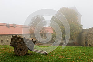 Beautiful view of the medieval castle courtyard with old wooden dray in the foreground