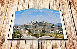 Beautiful view of the medieval town of San Gimignano Italy - Tuscany - 3D render of an opened photo book isolated on white