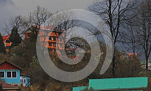 beautiful view of misty lachung hill station in autumn season, surrounded by forest and himalaya mountains