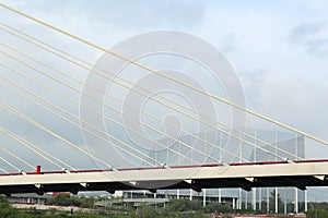 Beautiful view of modern bridge against cloudy sky photo