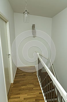 Beautiful view of modern home interior. Small cozy area of an apartment. Corridor with a beautiful spiral staircase.