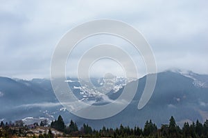 Beautiful view with morning fog in early spring, in Carpathian mountains, in Transylvania, Romania photo