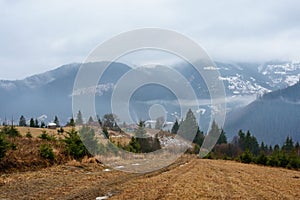 Beautiful view with morning fog in early spring, in Carpathian mountains, in Transylvania, Romania photo
