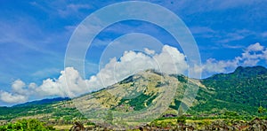 Beautiful view of Mount Guntur with white clouds against a bright blue sky