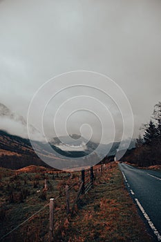 Beautiful view of mountain field by the road on a cloudy day