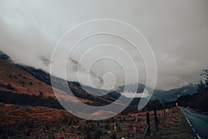 Beautiful view of mountain field by the road on a cloudy day