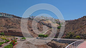 Beautiful view of mountain landscape with villas on top of mountains and taxis moving along serpentine mountain highway.